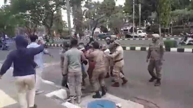 Kisruh petugas Satpol PP dengan para mahasiswa yang sedang berdemo di di gerbang kepemerintahan Kabupaten Bogor, Jawa Barat, Kamis (17/9/2020). [Istimewa]