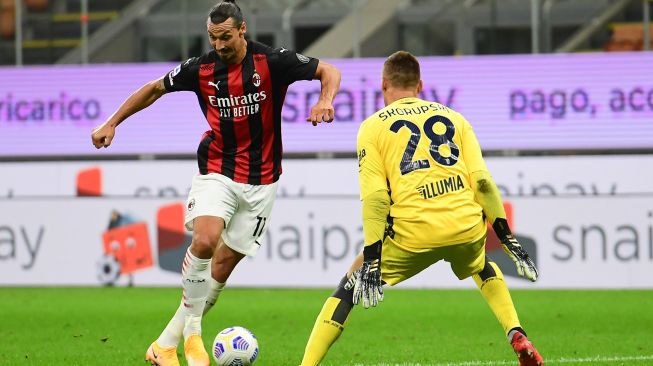 Penyerang AC Milan, Zlatan Ibrahimovic mencoba melewati kiper Bologna Lukasz Skorupski selama pertandingan sepak bola Serie A Italia AC Milan melawan Bologna di Stadion San Siro, Milan, Italia, Selasa (22/9) dini hari WIB. [MIGUEL MEDINA / AFP]