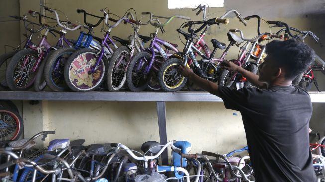 Pedagang menata sepeda bekas yang dijual kembali di tokonya di Jalan Banda Aceh-Medan, Desa Pagar Air, Aceh Besar, Aceh, Sabtu (26/9/2020).  [ANTARA FOTO/Irwansyah Putra]