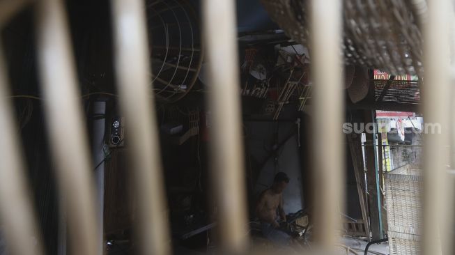 Perajin menyelesaikan perabot berbahan rotan di Jalan Pasar Minggu, Kalibata, Jakarta, Selasa (29/9/2020). [Suara.com/Angga Budhiyanto]