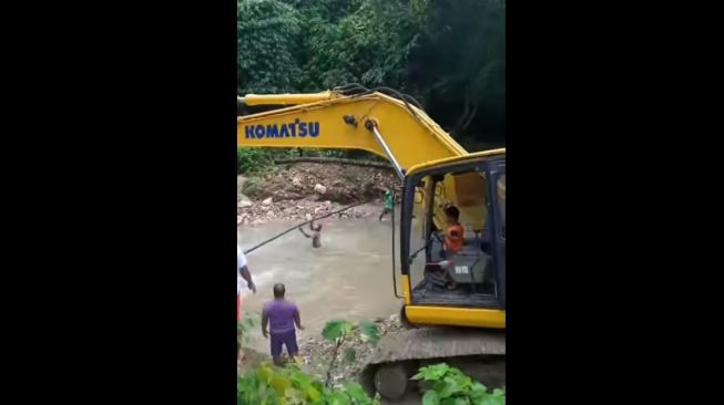 Aksi bocah operasikan ekskavator. [Facebook]