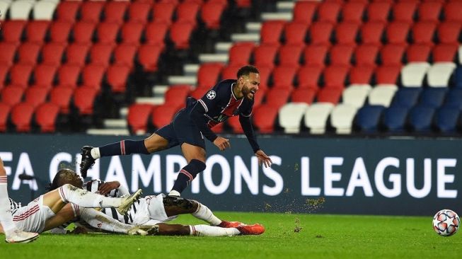 Fullback Manchester United, Aaron Wan-Bissaka (bawah) menekel penyerang PSG, Neymar pada laga Liga Champions 2020/2021 yang dihelat di Parc des Princes, Paris, Rabu (21/10/2020) dini hari WIB. [AFP]