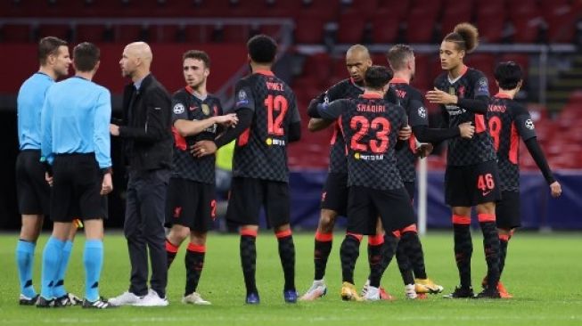 Para pemain Liverpool merayakan kemenangan atas Ajax Amsterdam usai pertandingan Liga Champions di Johan Cruijff Arena. Kenzo Tribouillard / AFP