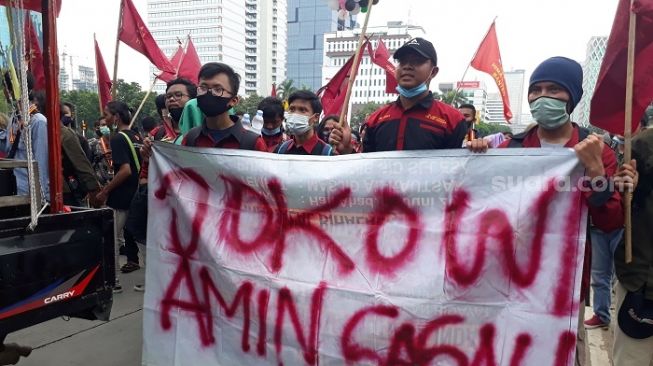 Massa mahasiswa membawa spanduk bertuliskan Jokowi Amin Gaga saat menggelar demo tolak UU Cipta Kerja di kawasan Patung Kuda, Jakpus. (Suara.com/Bagaskara).