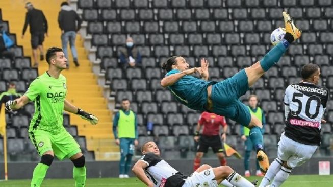 Striker AC Milan Zlatan Ibrahimovic melepaskan tendangan salto dan mencetak gol ke gawang Udinese dalam lanjutan Liga Italia di Friuli Stadium. Andreas SOLARO / AFP