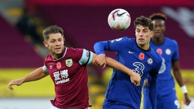 Pemain Chelsea Kai Havertz berebut bola dengan pemain Burnley dalam pertandingan Liga Premier Inggris di Turf Moor, Sabtu (31/10/2020). [AFP]