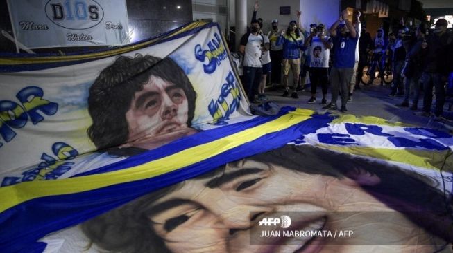 Ratusan Penggemar Dukung Kesembuhan Diego Armando Maradona pasca menjalani operasi otak di Buenos Aires, Argentina, Selasa (3/11/2020). [AFP]