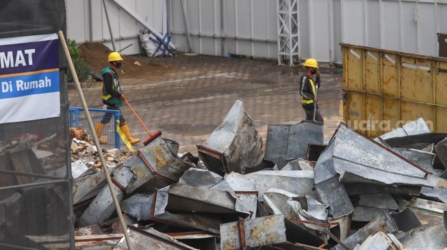 Pekerja menyelesaikan proyek renovasi gedung Sarinah  di Jalan MH. Thamrin, Jakarta Pusat, Minggu (8/11). [Suara.com/Alfian Winanto]