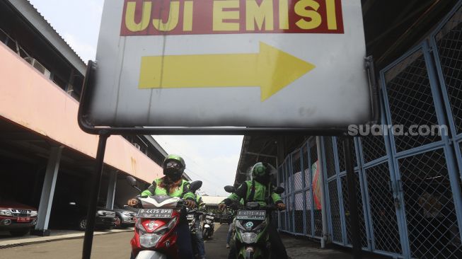 Sejumlah pengemudi ojek online mengantre untuk melakukan uji emisi kendaraan bermotor di Kantor Dinas Lingkungan Hidup DKI Jakarta, Kramat Jati, Jakarta, Kamis (19/11/2020). [Suara.com/Angga Budhiyanto]