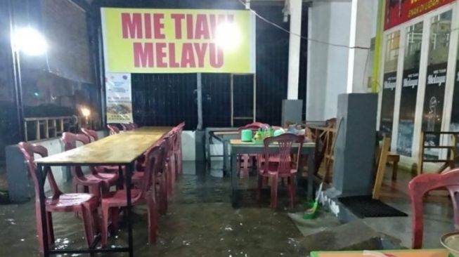 Air genangan banjir memasuki sebuah rumah makan di Kota Pontianak, Kamis (19/11) [ANTARA/Dedi]