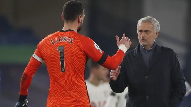 Manajer Tottenham Hotspur, Jose Mourinho (kanan) menyalami kiper Hugo Lloris usai laga Liga Inggris 2020/2021 kontra Chelsea di Stamford Bridge, London, Senin (30/11/2020) dini hari WIB. [MATTHEW CHILDS / POOL / AFP]