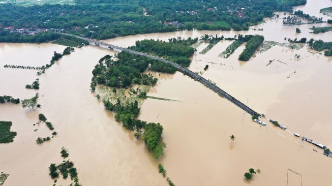 Foto udara banjir dari luapan Kali Klawing menggenangi jalur penghubung Kabupaten Banyumas-Purbalingga di Jembatan Linggamas, Desa Petir, Kalibagor, Banyumas, Jawa Tengah, Kamis (3/12/2020). [ANTARAFOTO/Idhad Zakaria]