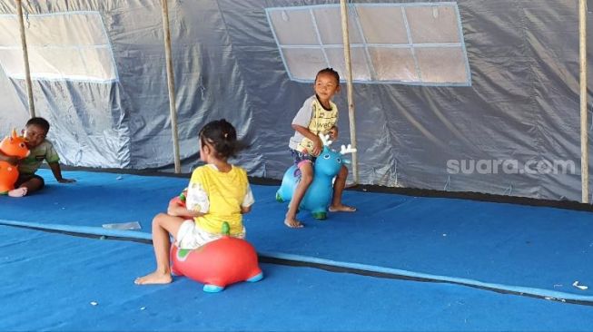 Anak-anak sedang bermain di taman ceria di barak pengungsian Glagaharjo, Cangkringan, Sleman, Jumat (4/11/2020). - (SuaraJogja.id/Hiskia Andika)