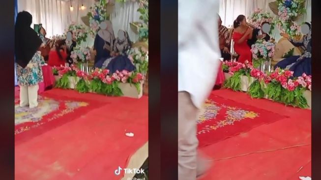 Bikin Geram, Biduan Malah Duduk di Pangkuan Pengantin Pria (tiktok.com/@cibey4)