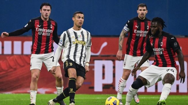 Penyerang Juventus, Cristiano Ronaldo coba mempertahankan bola dari gelandang AC Milan Franck Kessie dalam laga pekan ke-16 Liga Italia, di San Siro, Milan, Kamis (7/1/2021) dini hari WIB. [MIGUEL MEDINA / AFP].