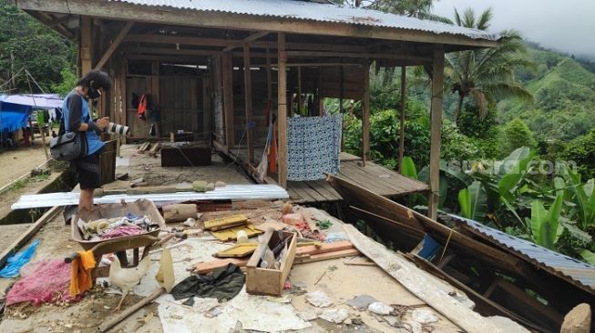 Pewarta foto saat memotret kondisi rumah warga korban gempa di Kecamatan Ulumanda, Kabupaten Majene, Sulawesi Barat. (Suara.com/Bagaskara)