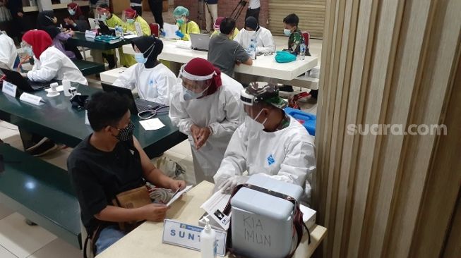 Penampakan pedagang saat mengikuti vaksinasi di Pasar Tanah Abang, Jakpus. (Suara.com/Yaumal)