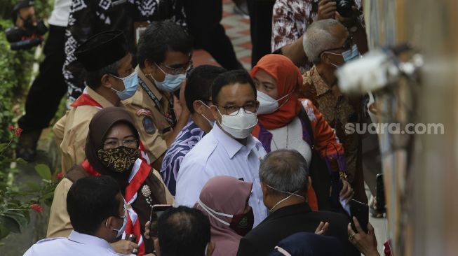 Gubernur DKI Jakarta, Anies Baswedan (tengah) meninjau jalannya vaksinasi COVID-19 untuk tenaga kependidikan di SMA Negeri 70 Jakarta, Rabu (24/2/2021). [Suara.com/Angga Budhiyanto]