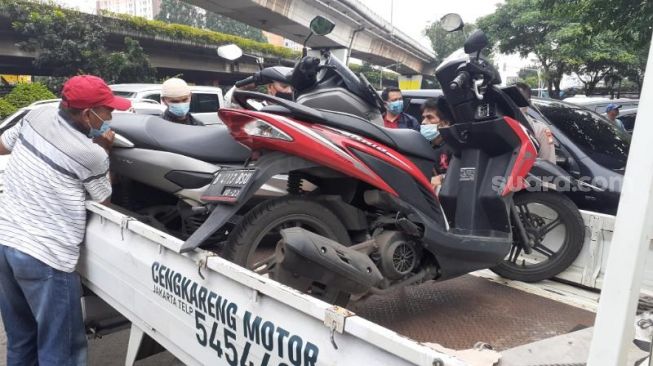 Polisi mengamankan dua unit sepeda motor diduga milik korban dari TKP penembakan oleh Bripka CS di Kafe Cengkerang, Jakarta Barat, Kamis (25/2/2021). [Suara.com/Yaumal Asri Adi Hutasuhut]