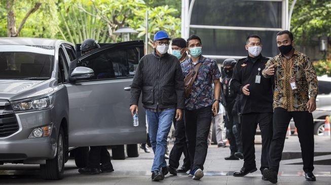 Gubernur Sulawesi Selatan Nurdin Abdullah (kiri) dikawal petugas setibanya di gedung KPK, Jakarta, Sabtu (27/2/2021). ANTARA FOTO/Dhemas Reviyanto