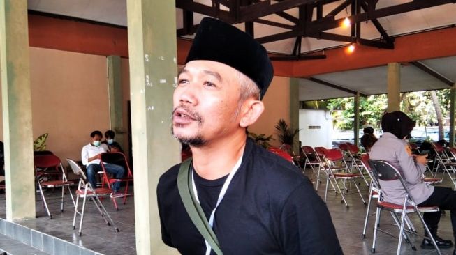 Rapper asal Yogyakarta, Marzuki Kill The DJ memberi keterangan pada wartawan saat vaksinasi seniman dan budayawan di Padepokan Seni Bagong Kussudiardja, Kapanewon Kasihan, Kabupaten Bantul, Rabu (10/3/2021). [Muhammad Ilham Baktora / SuaraJogja.id]