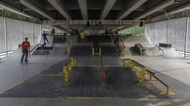 Suasana saat sejumlah remaja bermain skateboard di arena Skatepark Pasar Rebo, Jakarta Timur, Sabtu (13/3/2021). [Suara.com/Alfian Winanto]