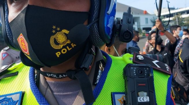 Polisi Lalu Lintas menunjukkan kamera Electric Traffic Law Enforcement (ETLE) Mobile yang terpasang di badan saat peluncuran di Polda Metro Jaya, Sabtu (20/3/2021). Polda Metro Jaya meluncurkan 30 perangkat kamera ETLE Mobile yang terpasang di badan petugas (body cam), helm (helmet cam), dan dashboard mobil (dash cam). ANTARA FOTO/Aprillio Akbar/hp