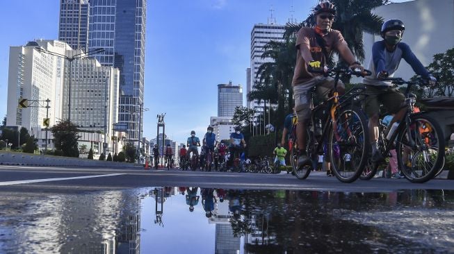 Warga bersepeda di kawasan Bundaran HI, Jakarta, Minggu (21/3/2021).  ANTARA FOTO/Muhammad Adimaja