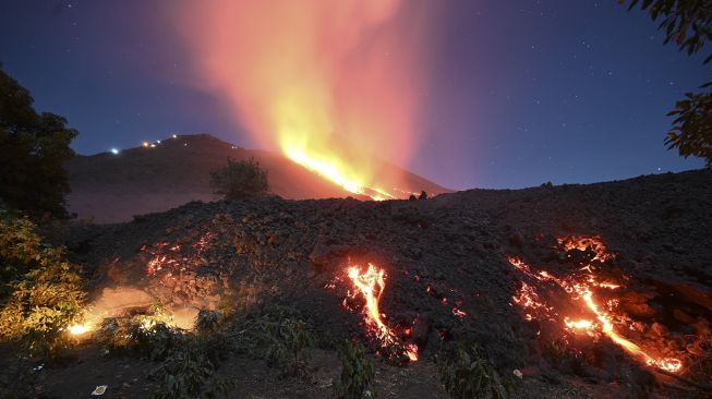 Lava mengalir dari Gunung Berapi Pacaya di pertanian La Brena di desa Patrocinio, San Vicente Pacaya, sekitar 60 kilometer selatan kota Guatemala, pada (25/3/2021). [Johan ORDONEZ / AFP]