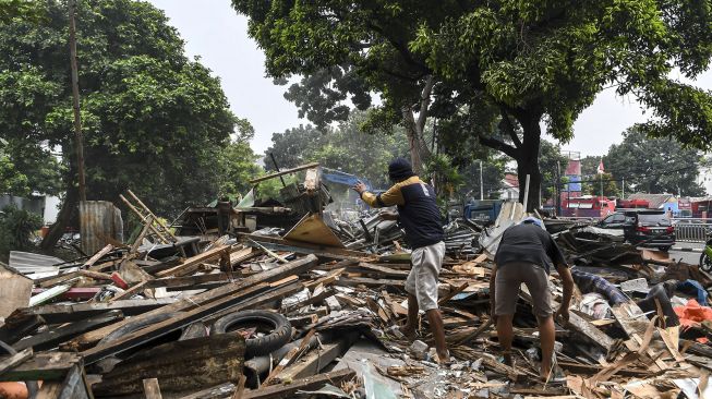 Warga memilah sisa bangunan miliknya yang telah ditertibkan di kawasan Menteng Dalam, Tebet, Jakarta Selatan, Selasa (30/3/2021). ANTARA FOTO/M Risyal Hidayat