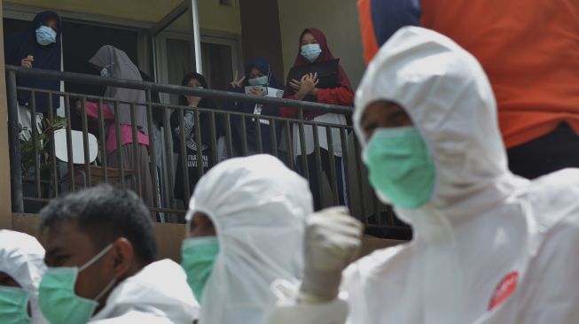 Petugas BPBD Padangpanjang berjalan melakukan penyemprotan disinfektan di asrama SMAN 1 Sumatera Barat, di Kota Padangpanjang, Sabtu (3/4/2021). [ANTARA FOTO/Iggoy el Fitra]