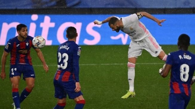 Pemain Real Madrid Karim Benzema mencetak gol ke gawang Eibar dalam pertandingan La Liga di Estadio Alfredo Di Stefano, Sabtu (3/4/2021). [AFP]