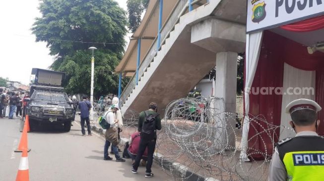 Aparat kepolisian berjaga di depan Pengadilan Negeri Jakarta Timur terkait persidangan Habib Rizieq Shihab, Selasa (6/4/2021). [Suara.com/Yaumal Asri Adi Hutasuhut]