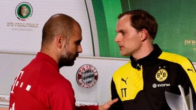 Thomas Tuchel dan Josep Guardiola berbincang jelang final Piala Jerman pada Mei 2016 di Munich. [AFP]