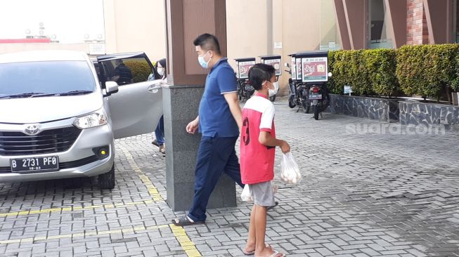 Angga Purnama Alamsyah, remaja 15 tahun yang masih duduk di bangku sekolah Kelas 8 SMP, menjajakan telur ayam kampung di depan sebuah restoran di Alam Sutera, Tangerang Selatan (Tangsel), Sabtu (17/4/2021). [SuaraJakarta.id/Wivy Hikmatullah]