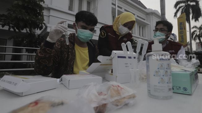 Petugas Puskesmas Gambir melakukan uji laboratorium makanan dari pedagang takjil di kawasan Petojo Utara, Gambir, Jakarta Pusat, Jumat (30/4/2021). [Suara.com/Angga Budhiyanto]