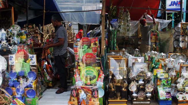 Penjual parsel merapihkan kiosnya di Jalan Pegangsaan Timur, Cikini, Jakarta Pusat, Jumat (30/4/2021).  [Suara.com/Dian Latifah]
