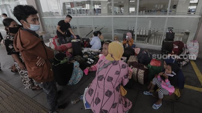 Sejumlah calon penumpang menunggu kedatangan bus di Terminal Pulo Gebang, Jakarta Timur, Selasa (4/5/2021). [Suara.com/Angga Budhiyanto]