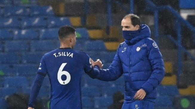 Pelatih Chelsea, Thomas Tuchel bersalaman dengan Thiago Silva. (NEIL HALL / POOL / AFP)