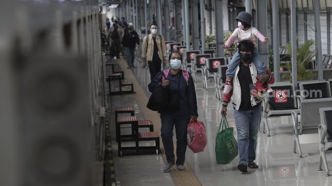 Sejumlah calon penumpang bersiap menaiki kereta di Stasiun Pasar Senen, Jakarta, Rabu (19/5/2021). [Suara.com/Angga Budhiyanto]