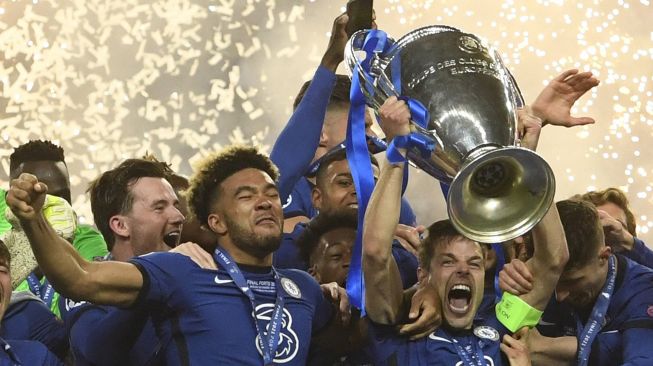 Bek Chelsea Cesar Azpilicueta (tengah) mengangkat trofi Liga Champions setelah memenangkan pertandingan final Liga Champions melawan Manchester City di Stadion Dragao, Porto, Portugal, Minggu (30/5/2021) dini hari WIB.  PIERRE-PHILIPPE MARCOU / POOL / AFP
