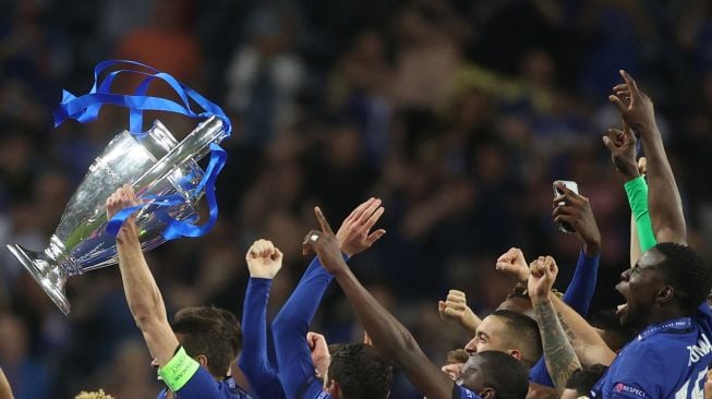 Bek Chelsea Cesar Azpilicueta (tengah) mengangkat trofi Liga Champions setelah memenangkan pertandingan final Liga Champions melawan Manchester City di Stadion Dragao, Porto, Portugal, Minggu (30/5/2021) dini hari WIB.  PIERRE-PHILIPPE MARCOU / POOL / AFP
