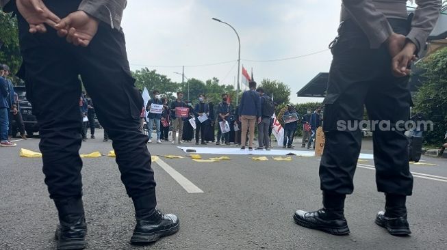 Polisi berjaga saat mahasiswa menggelar demi di gedung KPK, Rabu (2/6/2021). (Suara.com/Arga)