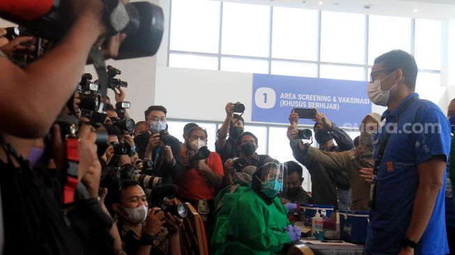 Menteri Pariwisata dan Ekonomi Kreatif Sandiaga Uno memberikan keterangan pers usai disuntik vaksin COVID-19 Astra Zeneca dosis pertama di Sentra Vaksinasi Central Park dan Neo Soho Mall, Jakarta, Selasa (8/6/2021). [Suara.com/Oke Atmaja]