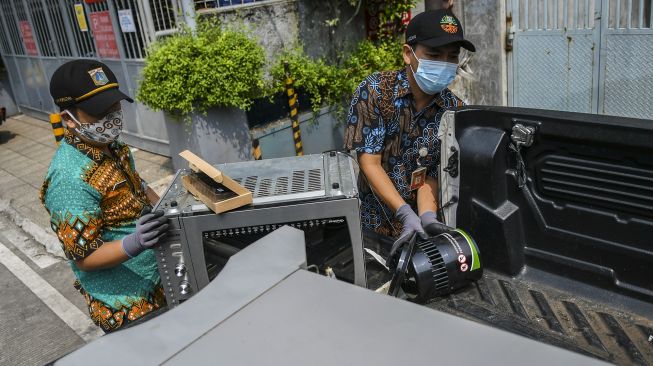 Petugas Dinas Lingkungan Hidup DKI Jakarta membawa sampah elektronik milik warga di kawasan Cempaka Putih, Jakarta, Kamis (10/6/2021).  ANTARA FOTO/Galih Pradipta