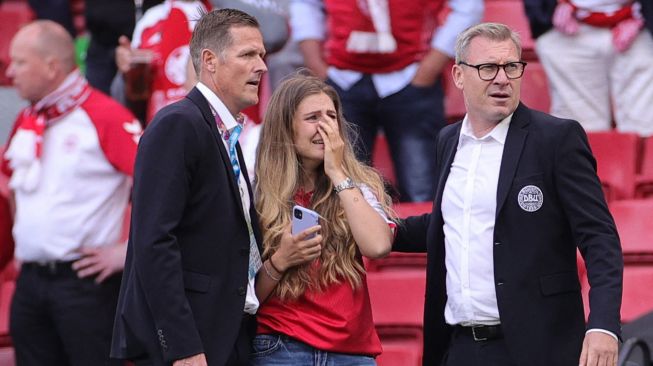 Sabrina Kvist Jensen istri gelandang Denmark Christian Eriksen,  menangis setelah melihat Eriksen pingsan selama pertandingan sepak bola Grup BEURO 2020 antara Denmark melawan Finlandia di Stadion Parken di Kopenhagen, Sabtu (12/6).  Jonathan NACKSTRAND / AFP / POOL