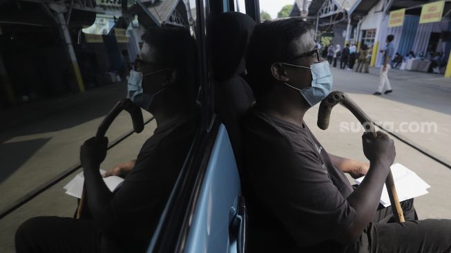 Penyandang disabilitas menunggu untuk mendapatkan vaksin COVID-19 di Pool Bluebird Kramat Jati, Jakarta, Senin (14/6/2021). [Suara.com/Angga Budhiyanto]