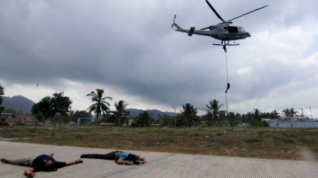 Prajurit Batalyon Intai Amfibi (Yontaifib) Korps Marinir TNI AL melakukan Fastrope pada aksi pembebasan sandera dalam latihan bersama United States Marines Corps Reconnaissance Unit bersandi Reconex 21-II di Pancer, Pesanggaran, Banyuwangi, Jawa Timur, Senin (15/6/2021).  ANTARA FOTO/Budi Candra Setya