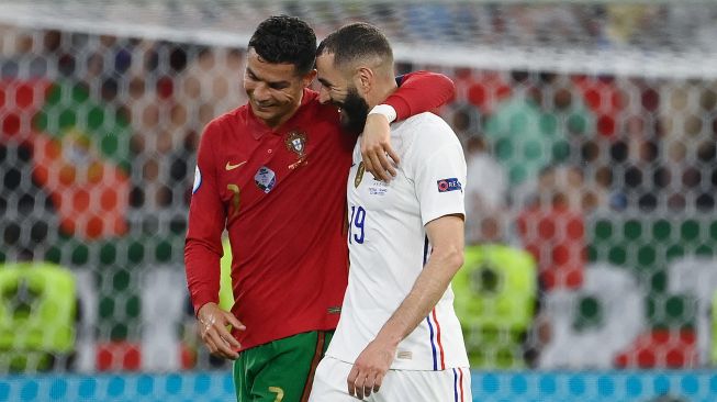 Pemain depan Portugal Cristiano Ronaldo dan pemain depan Prancis Karim Benzema berjalan bersama selama pertandingan sepak bola Grup F EURO 2020 antara Portugal melawan Prancis di Puskas Arena di Budapest, Kamis (24/6) dini hari WIB. FRANCK FIFE / KOLAM RENANG / AFP