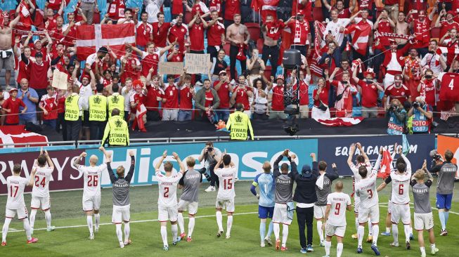 Para pemain Denmark merayakan kemenangan setelah memenangkan pertandingan sepak bola babak 16 besar UEFA EURO 2020 antara Wales dan Denmark di Johan Cruyff Arena, Amsterdam, pada (26/6/2021). [Koen van Weel / POOL / AFP]